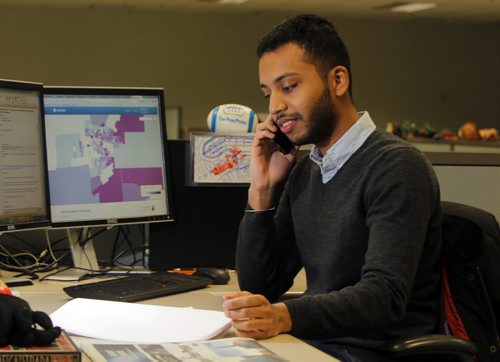 Inayat Singh poses for a photo at his work area in the news room. BORIS MINKEVICH/WINNIPEG FREE PRESS MARCH 16, 2015