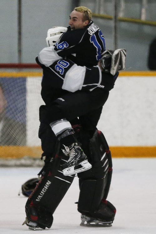 March 16, 2015 - 150316  -  Oak Park Raiders Conor Dowdell (16) and Nick Lewis (30) celebrate a win over the St Paul's Crusaders in the AAAA High School Hockey Championship game at St James Civic Centre  Monday, March 16, 2015. John Woods / Winnipeg Free Press