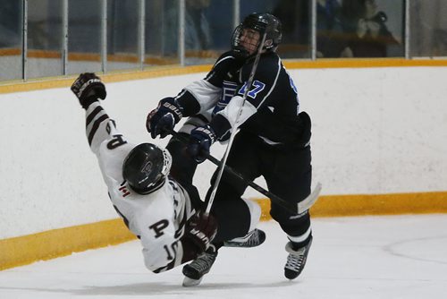 March 16, 2015 - 150316  -  Oak Park Raiders' Skai McLean (17) levels St Paul's Crusaders' Cole Zadro (10) in the AAAA High School Hockey Championship game at St James Civic Centre  Monday, March 16, 2015. John Woods / Winnipeg Free Press