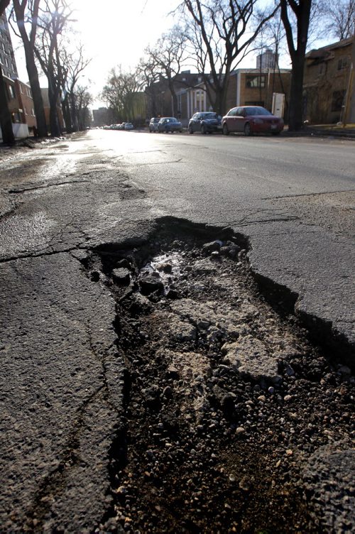 LOCAL - Pot holes in the 300 block of Stradbrook Ave. potholes. BORIS MINKEVICH/WINNIPEG FREE PRESS MARCH 17, 2015
