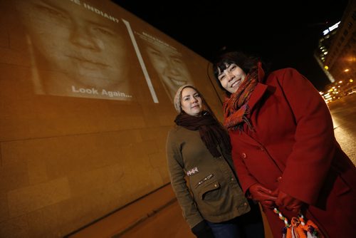 March 17, 2015 - 150317  -  Becca Taylor (L), a subject in the photography exhibit, is photographed with the photographer KC Adams in front of her image projected on the Winnipeg Art Gallery Tuesday, March 17, 2015. John Woods / Winnipeg Free Press