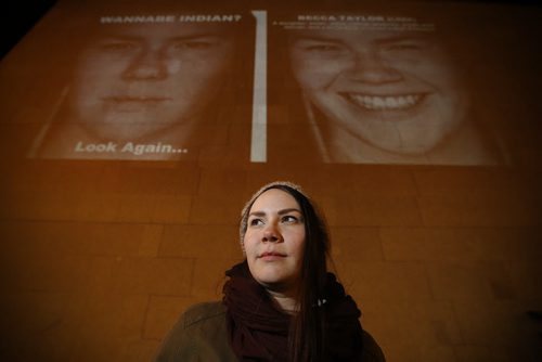 March 17, 2015 - 150317  -  Becca Taylor, a subject in the photography exhibit by KC Adams, is photographed in front of her image projected on the Winnipeg Art Gallery Tuesday, March 17, 2015. John Woods / Winnipeg Free Press