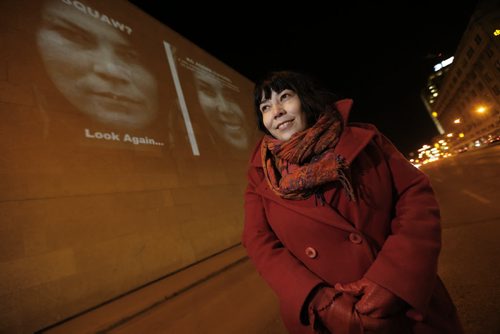 March 17, 2015 - 150317  - Photographer KC Adams is photographed in front of one of the images from her exhibit which is projected on the Winnipeg Art Gallery Tuesday, March 17, 2015. John Woods / Winnipeg Free Press