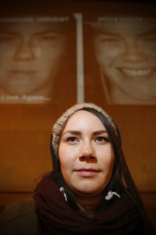 March 17, 2015 - 150317  -  Becca Taylor, a subject in the photography exhibit by KC Adams, is photographed in front of her image projected on the Winnipeg Art Gallery Tuesday, March 17, 2015. John Woods / Winnipeg Free Press