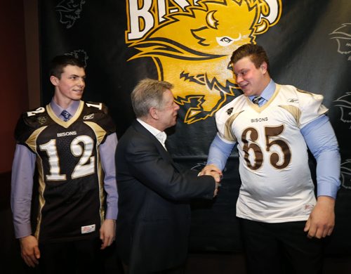 In centre, Bison Head Coach Brian Dobie with two local recruits Brenden Cowan at left and Braiden Watson at the U of M Bison Sports weekly press conference Wednesday. Paul Wiecek story Wayne Glowacki/Winnipeg Free Press March 18 2015