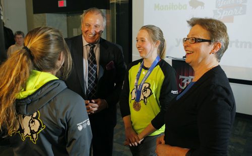 SPORTS - Funding announcement and highlight events for the Year of Sport held at Manitoba Sports Hall of Fame. Left, Children and Youth Opportunities Minister Melanie Wight. Second from right- Tourism, Culture, Heritage, Sport and Consumer Protection Minister Ron Lemieux. Ringette gold medal Canada Games winners left- Raeanne Wysocki and second from right Ryann Bannerman. BORIS MINKEVICH/WINNIPEG FREE PRESS MARCH 18, 2015