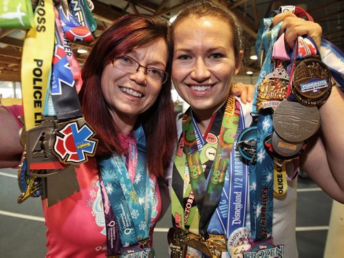 Annette Pratt (left) and Lisa Marquardson (right) have a lot of hardware from all the marathons they have taken part in. They go on "run-cations" to keep themselves motivated to stay in shape.  150318 March 18, 2015 Mike Deal / Winnipeg Free Press