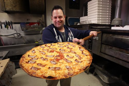 Jamie  Cinq-Mars  managing Partner with fresh pizza right out of oven at Tony's Master of Pizza, 1100 Pembina Hwy-Tony's has been in business for 50-plus years in the area- See Dave Sanderson 49.8 story - Mar 20, 2015   (JOE BRYKSA / WINNIPEG FREE PRESS)