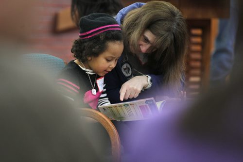 Five-year-old Nyesha Guma reads out loud to lawyer Bev Padeanu at the 5th annual West Broadway Lawyers for Literacy Read-A-Thon Saturday morning.   Standup photo  March 21, 2015 Ruth Bonneville / Winnipeg Free Press