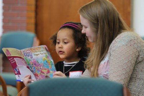 Five-year-old Nyesha Guma reads out loud to Laura Neirinck at the 5th annual West Broadway Lawyers for Literacy Read-A-Thon Saturday morning.   Standup photo  March 21, 2015 Ruth Bonneville / Winnipeg Free Press