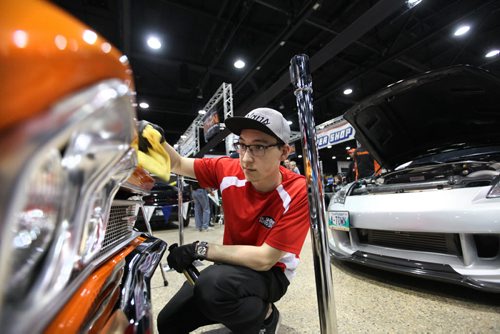 Kyle Takeshita a detailer with Dr. Shine, buffs up the front grill on a 1968 El Camino sports car at the World of Wheels show Saturday at the RBC Convention Centre.   Standup photo  March 21, 2015  Ruth Bonneville / Winnipeg Free Press