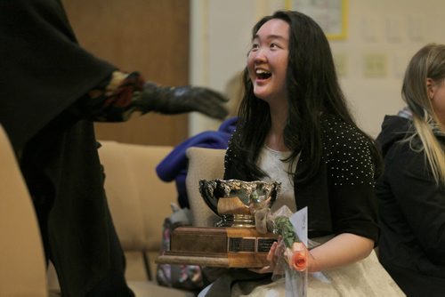 Jasmin Tang celebrates winning the Ladies' Orange Benevolent Association Trophy for the Girls under 14 category Saturday at Churchill Park United Church.   For Tuesday's photo page  Ruth Bonneville / Winnipeg Free Press March 21, 2015
