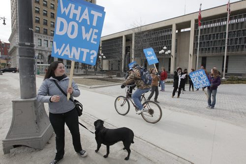 March 22, 2015 - 150322  -  About fifteen people and a dog gathered outside City Hall to express their support and opposition to Winnipeg Transit Sunday, March 22, 2015. John Woods / Winnipeg Free Press