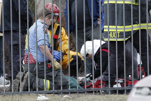 March 22, 2015 - 150322  -  The owner comforts her dog after a fire emergency crew revived the dog which was rescued from the Red River along Henderson close to Monroe Sunday, March 22, 2015. John Woods / Winnipeg Free Press