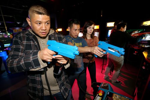 Alvin Mansilungan, Jeff S. and Teri S. playing one of the arcade games at Reset Interactive Ultralounge, Saturday, March 14, 2015. (TREVOR HAGAN/WINNIPEG FREE PRESS)