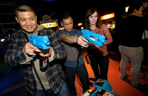 Alvin Mansilungan, Jeff S. and Teri S. playing one of the arcade games at Reset Interactive Ultralounge, Saturday, March 14, 2015. (TREVOR HAGAN/WINNIPEG FREE PRESS)