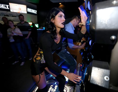 Katy Ruiz, 21, playing Speed of Light, an arcade game at Reset Interactive Ultralounge, Saturday, March 14, 2015. (TREVOR HAGAN/WINNIPEG FREE PRESS)