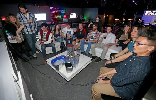 A group playing video games inside a VIP booth at Reset Interactive Ultralounge, Saturday, March 14, 2015. (TREVOR HAGAN/WINNIPEG FREE PRESS)