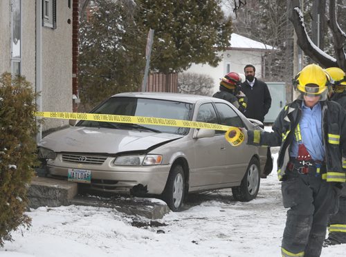 Winnipeg Fire Fighters at the scene of car that ended up in the yard of a home in the 600 block of Nottingham Ave. at Grey St. Monday. No one was injured in the single vehicle  mishap. Wayne Glowacki/Winnipeg Free Press March 23 2015