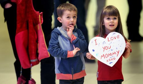 Welcoming Committee - Felix Rouire (4) left, and Camryn Hinchey (3) wait for their Team Canada's curling moms Jennifer Clark-Rouire and Jennifer Ifficer at James Richardson Airport Monday evening as members of the team arrived back with their silver world championship medals from Japan. See Paul Wiecek's story. March 23, 2015 - (Phil Hossack / Winnipeg Free Press)