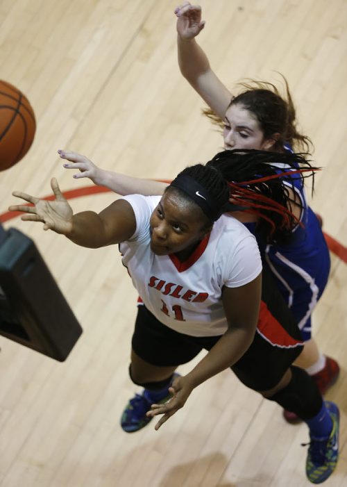 March 23, 2015 - 150323  -  Sisler Spartans' Kyanna Giles (11) makes the basket against Oak Park Raiders' Jessica Dyck (5) in the girls Manitoba High School AAAA Basketball Championship game at the U of Winnipeg Monday, March 23, 2015. John Woods / Winnipeg Free Press