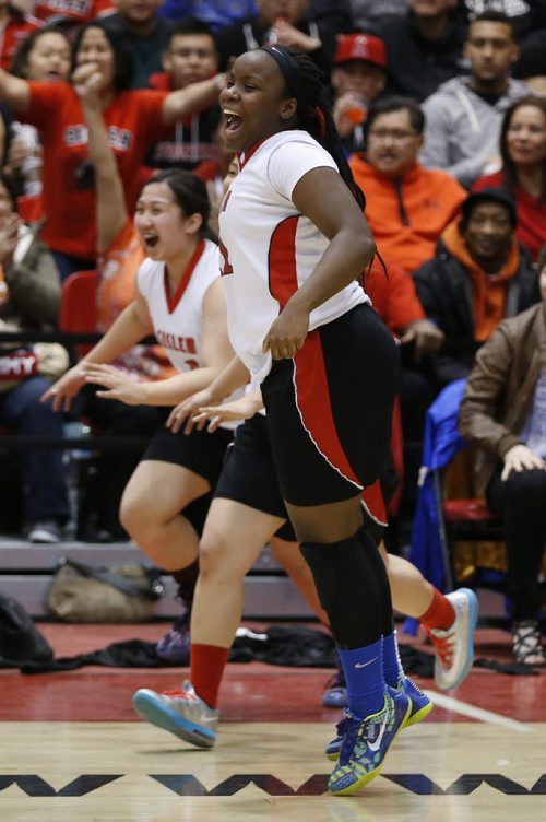 March 23, 2015 - 150323  -  Sisler Spartans' Kyanna Giles (11) celebrates a win over the Oak Park Raiders in the girls Manitoba High School AAAA Basketball Championship game at the U of Winnipeg Monday, March 23, 2015. John Woods / Winnipeg Free Press