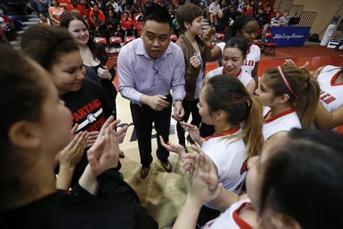 March 23, 2015 - 150323  -  Sisler Spartans coach Michael Tan  congratulates his team for a win over the Oak Park Raiders in the girls Manitoba High School AAAA Basketball Championship game at the U of Winnipeg Monday, March 23, 2015. John Woods / Winnipeg Free Press