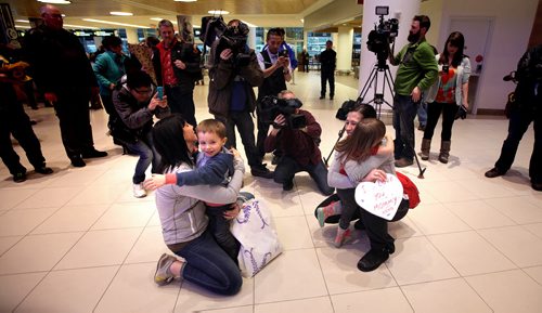 Welcoming Committee -  Team Canada's real winners 4 yr old Felix and 3 yr old Camryn welcome home their moms Jennifer Clark-Rouire (left) and Jill Officer arriving home from Japan with silver championship medals. See Paul Wiecek's story. March 23, 2015 - (Phil Hossack / Winnipeg Free Press)