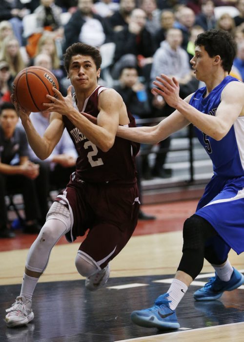 March 23, 2015 - 150323  -  St Paul's Crusaders' Arpad Farkas (2) drives through Oak Park Raiders' Nic Zorcic (5) in the boys Manitoba High School AAAA Basketball Championship game at the U of Winnipeg Monday, March 23, 2015. John Woods / Winnipeg Free Press