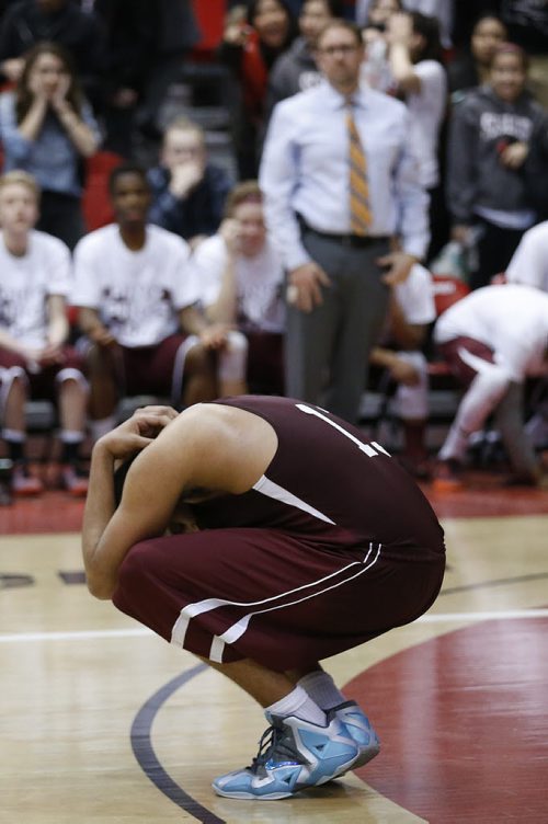 March 23, 2015 - 150323  - St Paul's Crusaders' Cam O'Hara (13) holds his head after fouling late in the fourth against Oak Park Raiders in the boys Manitoba High School AAAA Basketball Championship game at the U of Winnipeg Monday, March 23, 2015. John Woods / Winnipeg Free Press