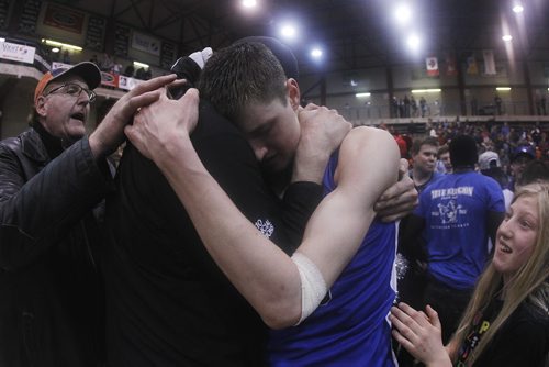 March 23, 2015 - 150323  -  Oak Park Raiders' William Kohler (13)  celebrates with family after defeating the St Paul's Crusaders in the boys Manitoba High School AAAA Basketball Championship game at the U of Winnipeg Monday, March 23, 2015. John Woods / Winnipeg Free Press
