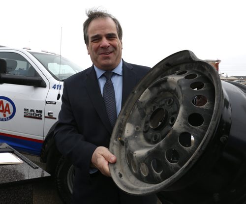 Mike Mager, president and CEO, CAA Manitoba holds a rim that was damaged by a pothole in Winnipeg at the  launch of the 4th annual Worst Roads campaign Tuesday. The campaign is urging Manitobans to pinpoint roads plagued with infrastructure issues like traffic congestion, pedestrian safety and potholes. The news conference was held on the parking lot of the  Fountain Tire on Pembina Highway. Kevin Rollason story Wayne Glowacki/Winnipeg Free Press March 24 2015