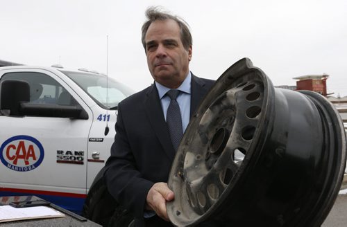 Mike Mager, president and CEO, CAA Manitoba holds a rim that was damaged by a pothole in Winnipeg at the  launch of the 4th annual Worst Roads campaign Tuesday. The campaign is urging Manitobans to pinpoint roads plagued with infrastructure issues like traffic congestion, pedestrian safety and potholes. The news conference was held on the parking lot of the  Fountain Tire on Pembina Highway. Kevin Rollason story Wayne Glowacki/Winnipeg Free Press March 24 2015