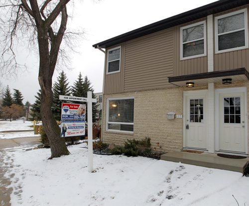 RESALE HOMES - 17-1445 Rothesay Street in North Kildonan. Realtor is Suzanne Mariani. Front of unit for sale. The one on the left. BORIS MINKEVICH/WINNIPEG FREE PRESS MARCH 24, 2015