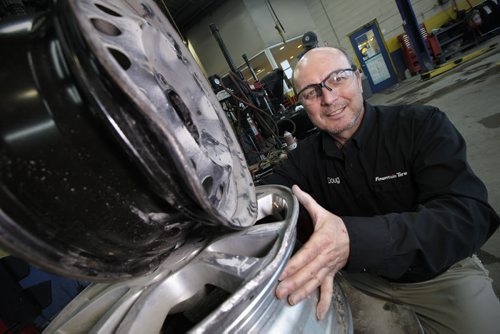 March 24, 2015 - 150324  -  Doug Webster, owner of Fountain Tire on south Pembina, shows some pot-hole damaged tire rims in his shop Tuesday, March 24, 2015. John Woods / Winnipeg Free Press