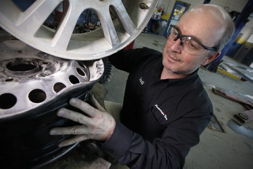 March 24, 2015 - 150324  -  Doug Webster, owner of Fountain Tire on south Pembina, shows some pot-hole damaged tire rims in his shop Tuesday, March 24, 2015. John Woods / Winnipeg Free Press