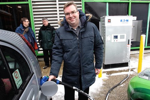 Micah Boisjoli a member of the Manitoba EV Club takes the opportunity to plug in his Mitsubishi MiEV car after the unveiling of the recently installed Level 3 (30KW DC) electric vehicle (EV) quick charging station at the RRC Notre Dame campus. This new charger can charge an EV car in about 30 mins and is the first of its kind in Manitoba. 150325 March 25, 2015 Mike Deal / Winnipeg Free Press