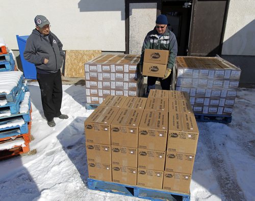 GARSON, MB - PERFECT PIEROGIES - left, Lawrence Porhownik watches some boxes of pierogies getting loaded up by a delivery guy. BORIS MINKEVICH/WINNIPEG FREE PRESS MARCH 26, 2015