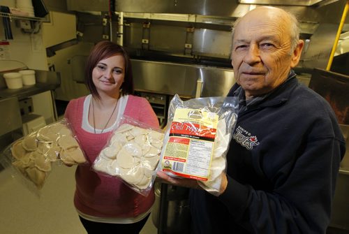 GARSON, MB - PERFECT PIEROGIES - Courtney Deise and Lawrence Porhownik hold some of the yummy product. They are inside the company where the machines cook and cool the pierogies. BORIS MINKEVICH/WINNIPEG FREE PRESS MARCH 26, 2015