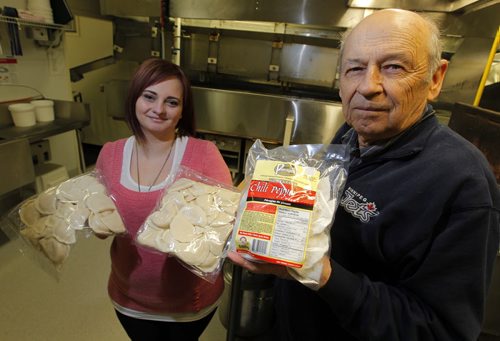GARSON, MB - PERFECT PIEROGIES - Courtney Deise and Lawrence Porhownik hold some of the yummy product. They are inside the company where the machines cook and cool the pierogies. BORIS MINKEVICH/WINNIPEG FREE PRESS MARCH 26, 2015