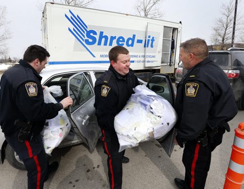 Members of the Winnipeg Police Service were out Friday lending a hand to citizens who brought their documents to the St. Vital Shopping Centre  parking lot from 11:30 a.m. to 12:30 p.m.  for the free Shred-It event part of  Fraud Awareness Month.  Wayne Glowacki/Winnipeg Free Press March 27 2015