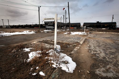 Lots for sale adjacent to the rail yards and a train made up of oil tanker cars flowing through the city center. See story. March 27, 2015 - (Phil Hossack / Winnipeg Free Press)