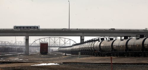 Oil tanker cars flow through CP rail yards and the city center. See story. March 27, 2015 - (Phil Hossack / Winnipeg Free Press)