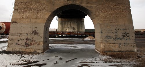 View from under the Arlington street Bridge at the CP rail yards and the city center. See story. March 27, 2015 - (Phil Hossack / Winnipeg Free Press)