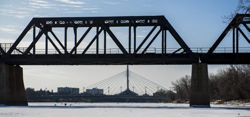 150328 Winnipeg - DAVID LIPNOWSKI / WINNIPEG FREE PRESS  The Esplanade Riel is silhouetted against the Waterfront Drive rail bridge early Saturday morning.