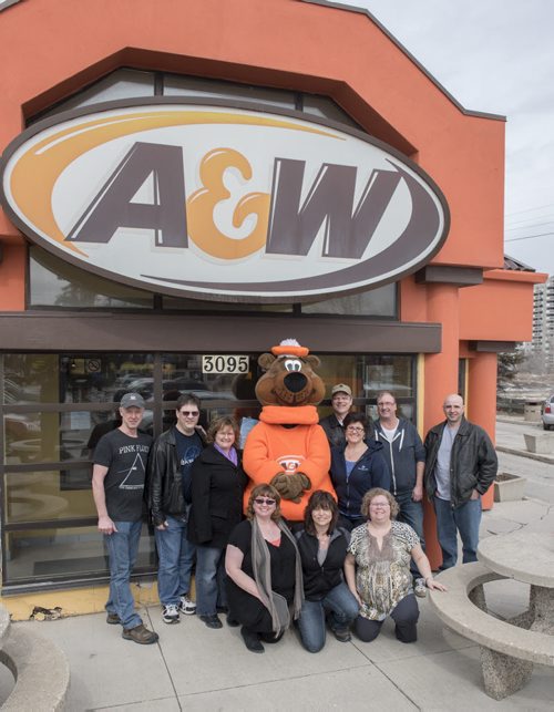 150328 Winnipeg - DAVID LIPNOWSKI / WINNIPEG FREE PRESS  Brenda and Ian McCarthy with their friends Sunday afternoon. The two have been married since 1994, and met at the Kirkfield A&W on Portage Ave. Brenda worked there, and Ian was a regular. The two stopped into the location on their wedding day,  and Root Bear the mascot came dressed as such at their wedding. This A&W was the first to open in Canada back in 1956 and Sunday March 28, 2015 was the last day of business. They are relocating to Portage & Sturgeon on April 9, 2015.