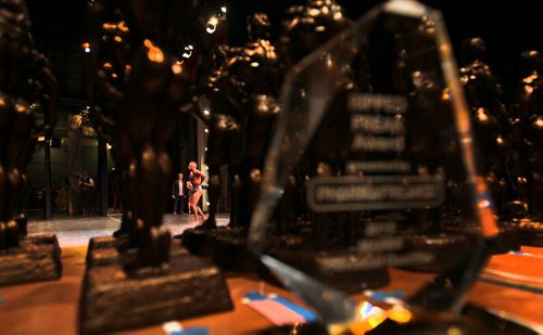 Body builders across Manitoba compete in the Manitoba Bodybuilding  Association Provincial Qualifier competition at Pantages Saturday night.  A male competitor poses for the judges and crowd as a table full of trophies await the winners.  March 28, 2015 Ruth Bonneville / Winnipeg Free Press.