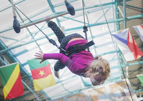 Dasha Levterov, 8, suspends on the trapeze at the Festival of Fools at the Forks on Sunday. Sarah Taylor / Winnipeg Free Press