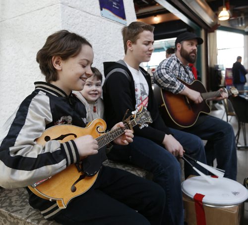 Spring break for the Janzen Boys from left, Mick,10, Joe,5, Simon,14, and their father John Janzen means more time to do what they really enjoy that is busking at The Forks on a Monday morning. Wayne Glowacki/Winnipeg Free Press March 30  2015