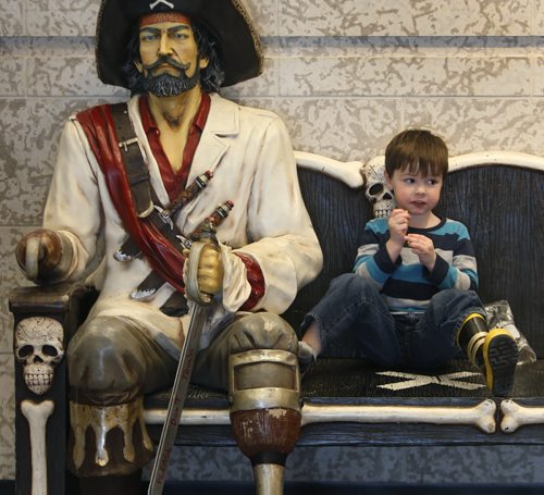 Thomas Dalman Bettes, 3, has a snack on a bench in the foyer beside the entrance to the Real Pirates: The Untold Story of the Whydah from Slave Ship to Pirate Ship touring exhibition at The Manitoba Museum until April 19. Wayne Glowacki/Winnipeg Free Press March 30  2015